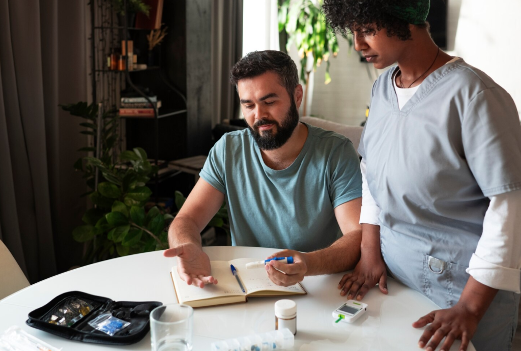 A man at a table with a healthcare provider, discussing diabetes management tools and medications.